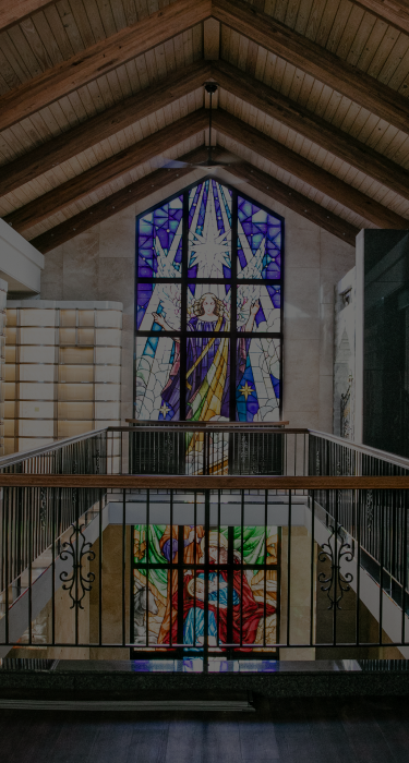 Premium Curved Glass fronted niches in front of stained glass window